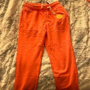 Pair of Coral colored joggers